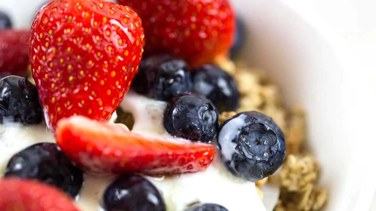 Çilek, yaban mersini ve granola ile hazırlanmış yoğurt kasesi